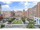 Expansive view of Ponce City Market, highlighting its brick architecture, parking area, green space, and vibrant mural at 873 Monroe Ne Cir, Atlanta, GA 30308
