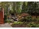 Lush backyard featuring a custom outdoor bar, seating area, and mature landscaping for a private retreat at 225 Cotton Field Ct, Alpharetta, GA 30022