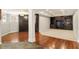Finished basement with wood floors, carpeted area, built-in shelving, and crown moulding at 225 Cotton Field Ct, Alpharetta, GA 30022