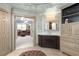 Bathroom featuring custom sink, marble countertop, and access to a large walk-in closet at 225 Cotton Field Ct, Alpharetta, GA 30022