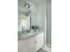 Bathroom with decorative vanity, marble countertop, large mirror, modern lighting and neutral walls at 225 Cotton Field Ct, Alpharetta, GA 30022