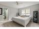 Neutral bedroom with carpet, ceiling fan, and view of connected bathroom with toilet at 225 Cotton Field Ct, Alpharetta, GA 30022