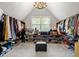 Extensive closet with hanging rods, shelving, and a central ottoman at 225 Cotton Field Ct, Alpharetta, GA 30022