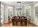 Elegant dining room featuring a chandelier, and large windows providing ample natural light at 225 Cotton Field Ct, Alpharetta, GA 30022