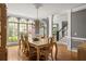 Bright dining room featuring hardwood floors, large windows, and a view of the home's entrance at 225 Cotton Field Ct, Alpharetta, GA 30022