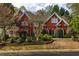 Brick two-story home with manicured landscaping and brick retaining wall at 225 Cotton Field Ct, Alpharetta, GA 30022