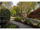 Well-manicured landscaping and a stone pathway leading to a traditional red brick home at 225 Cotton Field Ct, Alpharetta, GA 30022