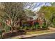 Traditional two-story brick home with manicured landscaping, mature trees, and well-maintained lawn at 225 Cotton Field Ct, Alpharetta, GA 30022