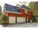 The exterior of this home features a two-car garage and back entrance to the home at 225 Cotton Field Ct, Alpharetta, GA 30022