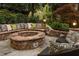 Inviting outdoor area with a stone fire pit and comfortable seating perfect for relaxation at 225 Cotton Field Ct, Alpharetta, GA 30022