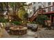 Relaxing outdoor space with a fire pit, comfortable seating, and charming string lights on the home's deck at 225 Cotton Field Ct, Alpharetta, GA 30022