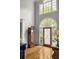 The home's foyer has hardwood floors, large windows, and decoratively stained glass at 225 Cotton Field Ct, Alpharetta, GA 30022