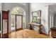 Elegant foyer features a decorative glass door, hardwood floors, and a stylish console table at 225 Cotton Field Ct, Alpharetta, GA 30022