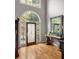 Stately foyer with hardwood flooring, tall ceilings, large windows, and stained glass front door at 225 Cotton Field Ct, Alpharetta, GA 30022