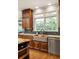 Charming kitchen boasts custom copper sink, granite countertops, and modern stainless steel appliances at 225 Cotton Field Ct, Alpharetta, GA 30022