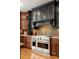 The kitchen features a stainless steel range, complementing the stylish dark and wood cabinets at 225 Cotton Field Ct, Alpharetta, GA 30022
