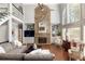 Spacious living room features a stone fireplace, built-in shelving, and a two-story ceiling at 225 Cotton Field Ct, Alpharetta, GA 30022