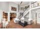 Open living room boasts high ceilings, a staircase, and seamless flow to the adjacent kitchen at 225 Cotton Field Ct, Alpharetta, GA 30022