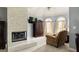 Cozy main bedroom featuring a fireplace, seating area, and plush carpeting at 225 Cotton Field Ct, Alpharetta, GA 30022