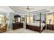 Main bedroom with a tray ceiling, four-poster bed, and neutral décor at 225 Cotton Field Ct, Alpharetta, GA 30022
