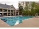 Community pool with a large deck and ample space for seating at the neighborhood clubhouse at 225 Cotton Field Ct, Alpharetta, GA 30022