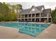 Resort-style community pool surrounded by lounge chairs, mature trees, and impeccable landscaping at 225 Cotton Field Ct, Alpharetta, GA 30022