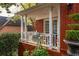 A cozy porch with seating area is accessible from the outside and inside at 225 Cotton Field Ct, Alpharetta, GA 30022