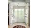 Luxurious glass enclosed shower with double shower heads, bench and accent window at 225 Cotton Field Ct, Alpharetta, GA 30022