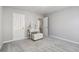 Carpeted bedroom featuring a vanity, storage ottoman, and easy access to a private bathroom at 2319 White Alder Dr, Buford, GA 30519