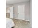 Neutral bedroom with plush carpet and white doors leading to other rooms at 2319 White Alder Dr, Buford, GA 30519