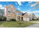 Charming two-story house with stone accents, neat landscaping, and a two-car garage on a sunny day at 2319 White Alder Dr, Buford, GA 30519