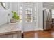Bright foyer featuring a glass-paneled door, wood floors, and a stylish console table at 2319 White Alder Dr, Buford, GA 30519