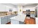 Bright kitchen featuring granite countertops, white cabinets, stainless steel appliances, and hardwood floors at 2319 White Alder Dr, Buford, GA 30519