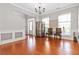 Elegant living room with hardwood floors, large windows, and a contemporary chandelier at 2319 White Alder Dr, Buford, GA 30519
