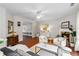 Comfortable living room with neutral decor, fireplace, hardwood floors, and plenty of natural light at 2319 White Alder Dr, Buford, GA 30519