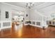 Open-concept living space with hardwood floors, staircase, and a view into the cozy living room at 2319 White Alder Dr, Buford, GA 30519