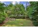 Green backyard featuring a stone water feature and lush trees at 404 Princeton Ne Way, Atlanta, GA 30307