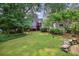 Large backyard with lush grass, patio, and a deck on the back of the house at 404 Princeton Ne Way, Atlanta, GA 30307