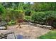 Secluded gravel backyard with wooden chair and mature plantings at 404 Princeton Ne Way, Atlanta, GA 30307