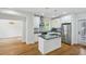 Modern kitchen featuring white cabinets, stainless steel appliances, gray countertops, and an island with a sink at 404 Princeton Ne Way, Atlanta, GA 30307