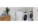 Bright laundry room with modern, front-loading washer and dryer at 404 Princeton Ne Way, Atlanta, GA 30307