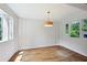 Bright room with white walls, hardwood floors, modern lighting, and natural light from multiple windows at 404 Princeton Ne Way, Atlanta, GA 30307