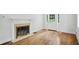 Inviting living room with a decorative fireplace, hardwood floors, and a bright white door with glass panels at 404 Princeton Ne Way, Atlanta, GA 30307