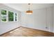 Bright room with white walls, hardwood floors, modern lighting, and natural light from multiple windows at 404 Princeton Ne Way, Atlanta, GA 30307