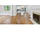 Open living space with a modern fireplace, hardwood floors, and a connected kitchen with stainless steel appliances at 404 Princeton Ne Way, Atlanta, GA 30307