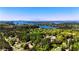Expansive aerial view showcasing lush forests, homes, and tranquil lake waters at 416 Blue Sky Cir, Acworth, GA 30102