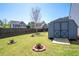 Landscaped backyard featuring a well-maintained lawn, storage shed and privacy fence at 416 Blue Sky Cir, Acworth, GA 30102