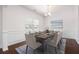 Elegant dining room featuring wainscoting, modern lighting, and hardwood floors at 416 Blue Sky Cir, Acworth, GA 30102