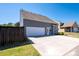 View of the home's exterior highlighting the spacious driveway and attached two car garage at 416 Blue Sky Cir, Acworth, GA 30102