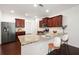 Modern kitchen featuring a breakfast bar with seating, stainless steel appliances, and sleek cabinetry at 416 Blue Sky Cir, Acworth, GA 30102